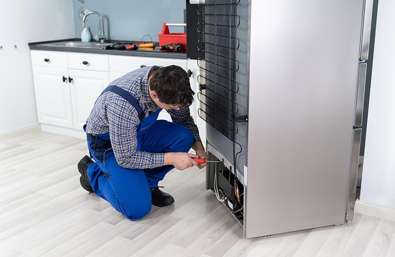 A man doing fridge repairs in brisbane