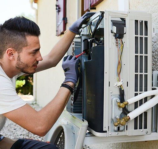 A man doing ducted air conditioning repair in brisbane