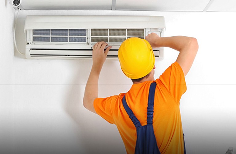 A man doing air conditioning servicing in brisbane