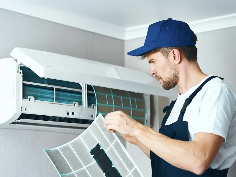 Technician Cleaning Air Conditioner Brisbane