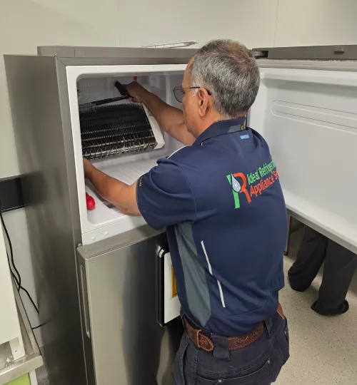 Fridge Repairs Brisbane – Expert Technician Inspecting Refrigerator